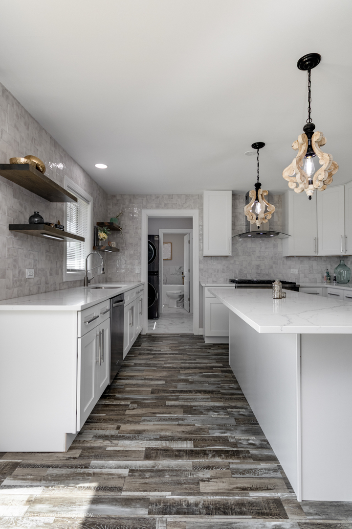 38W715 Huntley Road West Dundee, IL 60118 - Photo 31 of 42 a large white kitchen with kitchen island a sink stainless steel appliances and cabinets