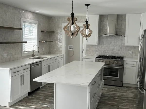 a kitchen with a stove and a refrigerator
