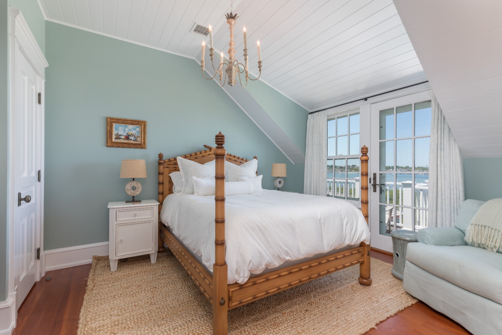 20 Berkeley Avenue Nantucket, MA 02554 - Photo 29 of 30 a bedroom with a large bed and a chandelier