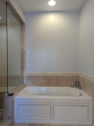 a bathroom with a bathtub and shower