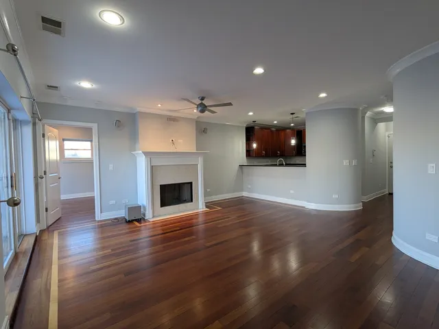 a view of a room wooden floor and fire place