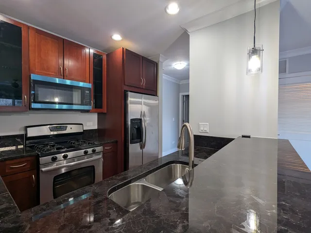 a kitchen with a refrigerator stove and microwave