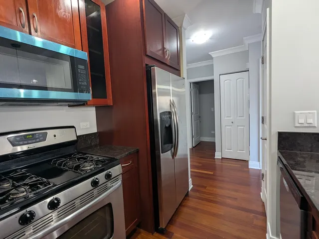 a kitchen with stainless steel appliances granite countertop a stove and a refrigerator