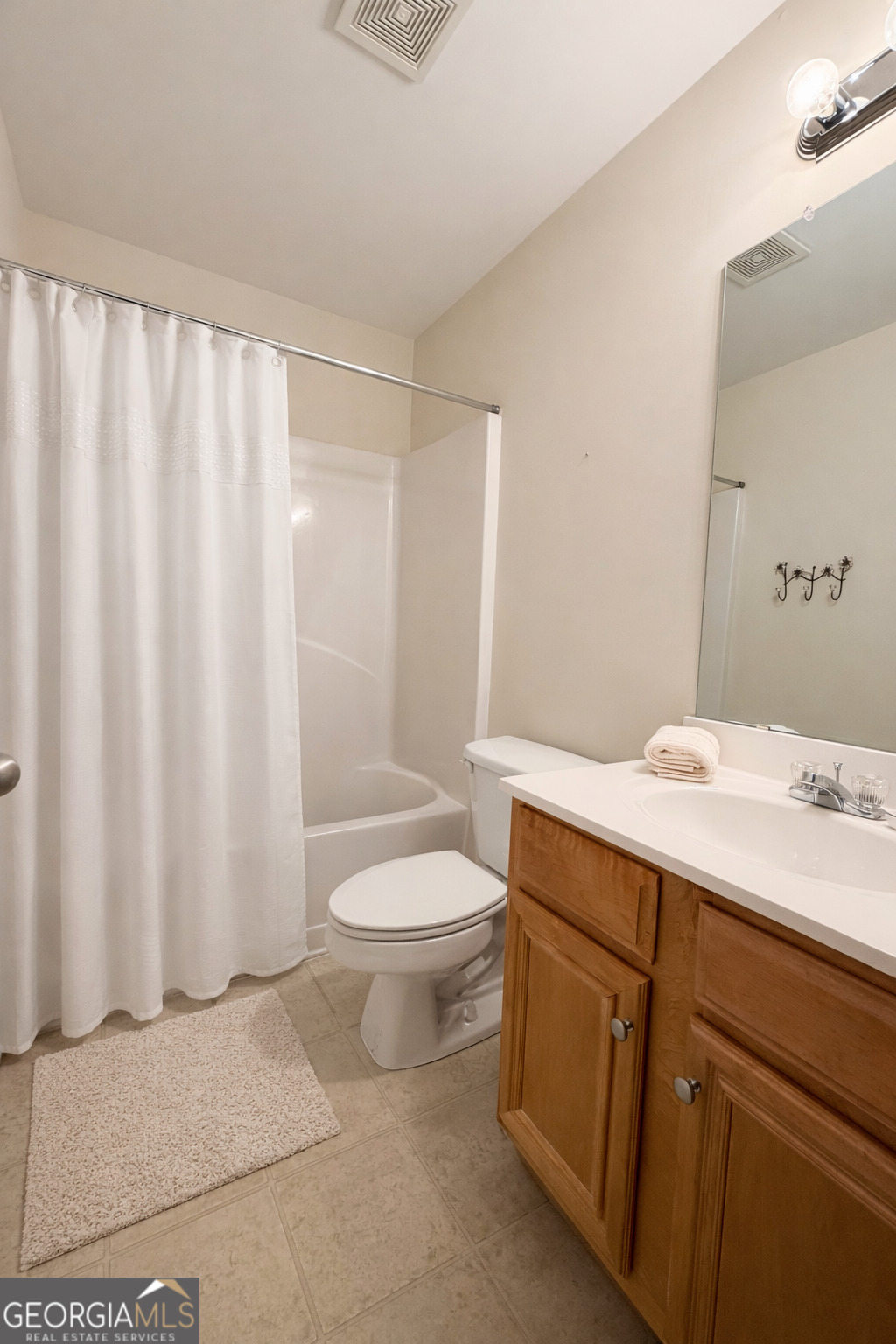 141 C3 Mill Carrollton, GA 30116 - Photo 22 of 27 a bathroom with a sink a toilet and shower curtain