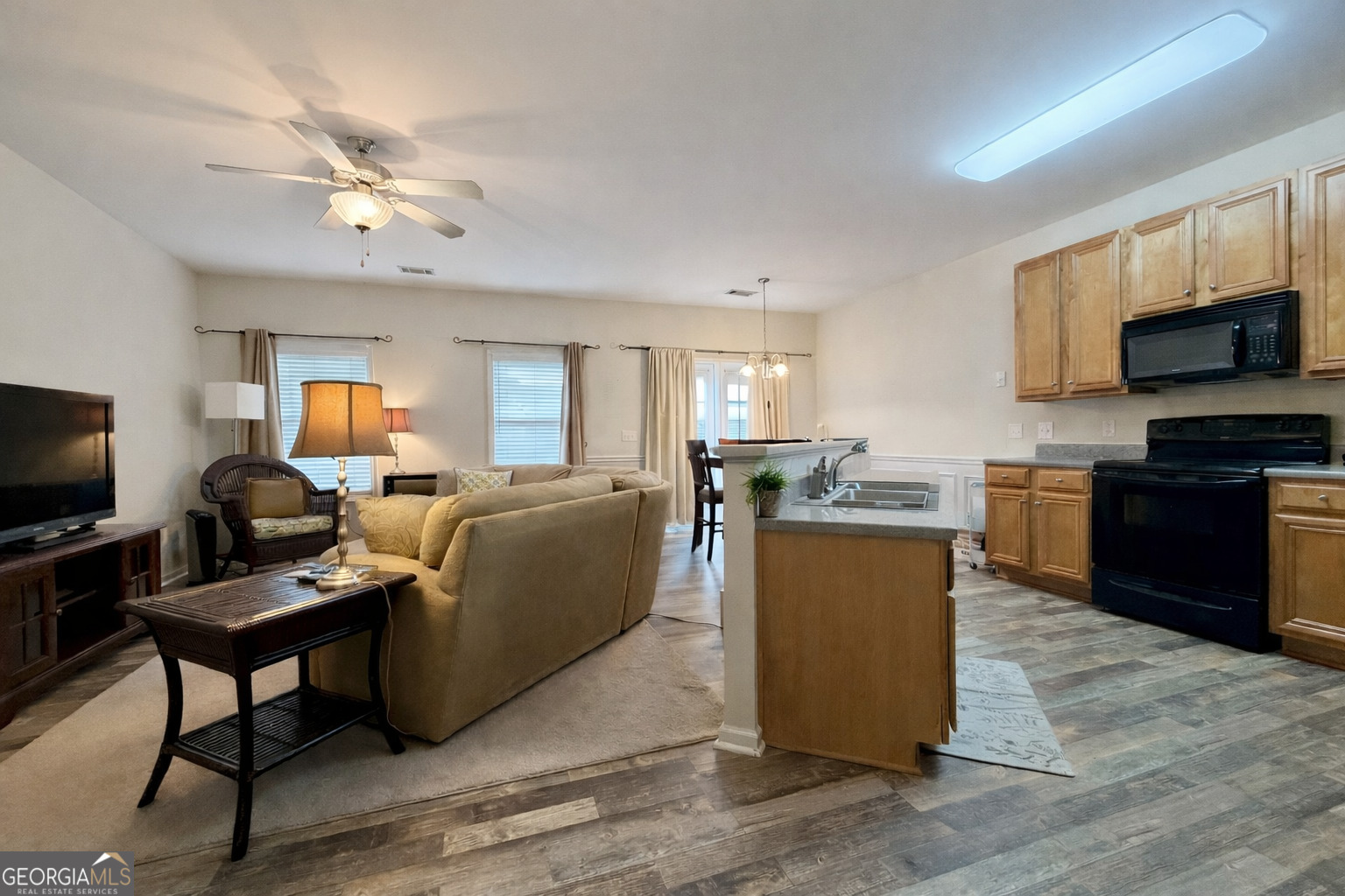 141 C3 Mill Carrollton, GA 30116 - Photo 5 of 27 a living room with furniture a flat screen tv and kitchen view