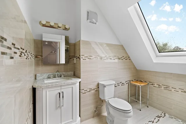 a white toilet sitting next to a bathroom sink