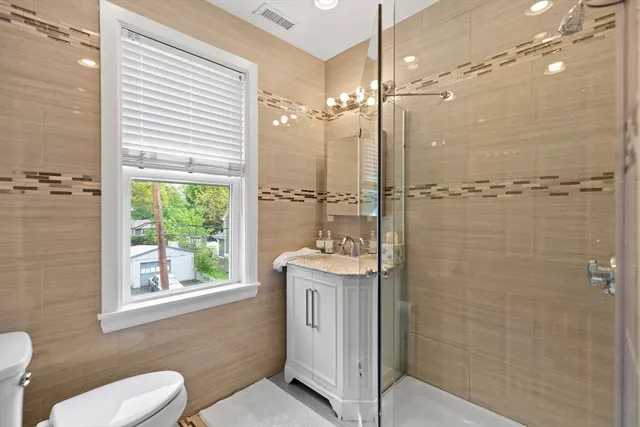 a bathroom with a toilet a sink and shower