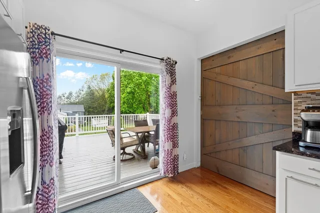 a view of a balcony with chair and floor to ceiling window