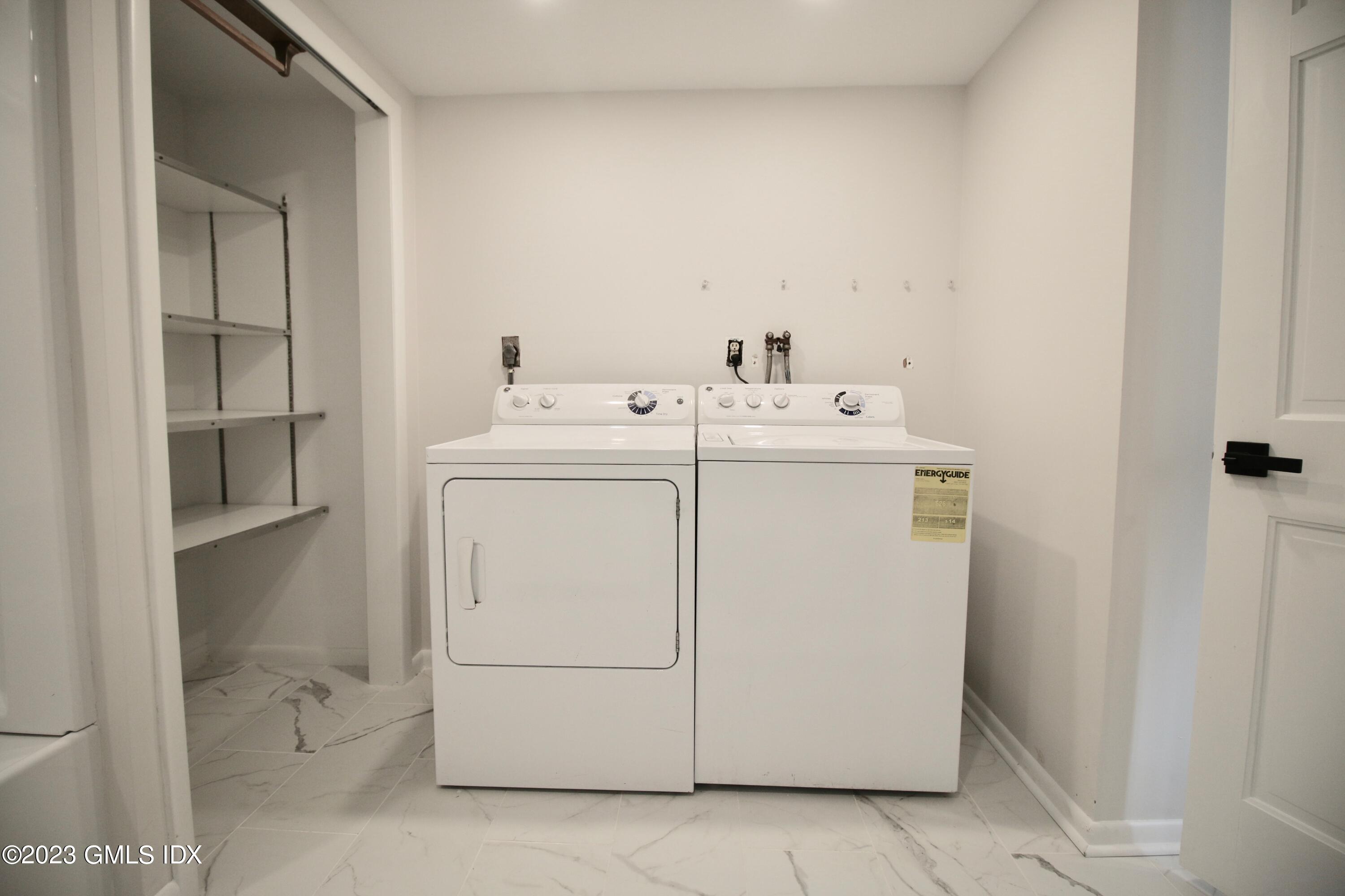 25 Bible Street, Unit 1 Cos Cob, CT 06807 - Photo 11 of 12 a utility room with dryer and washer