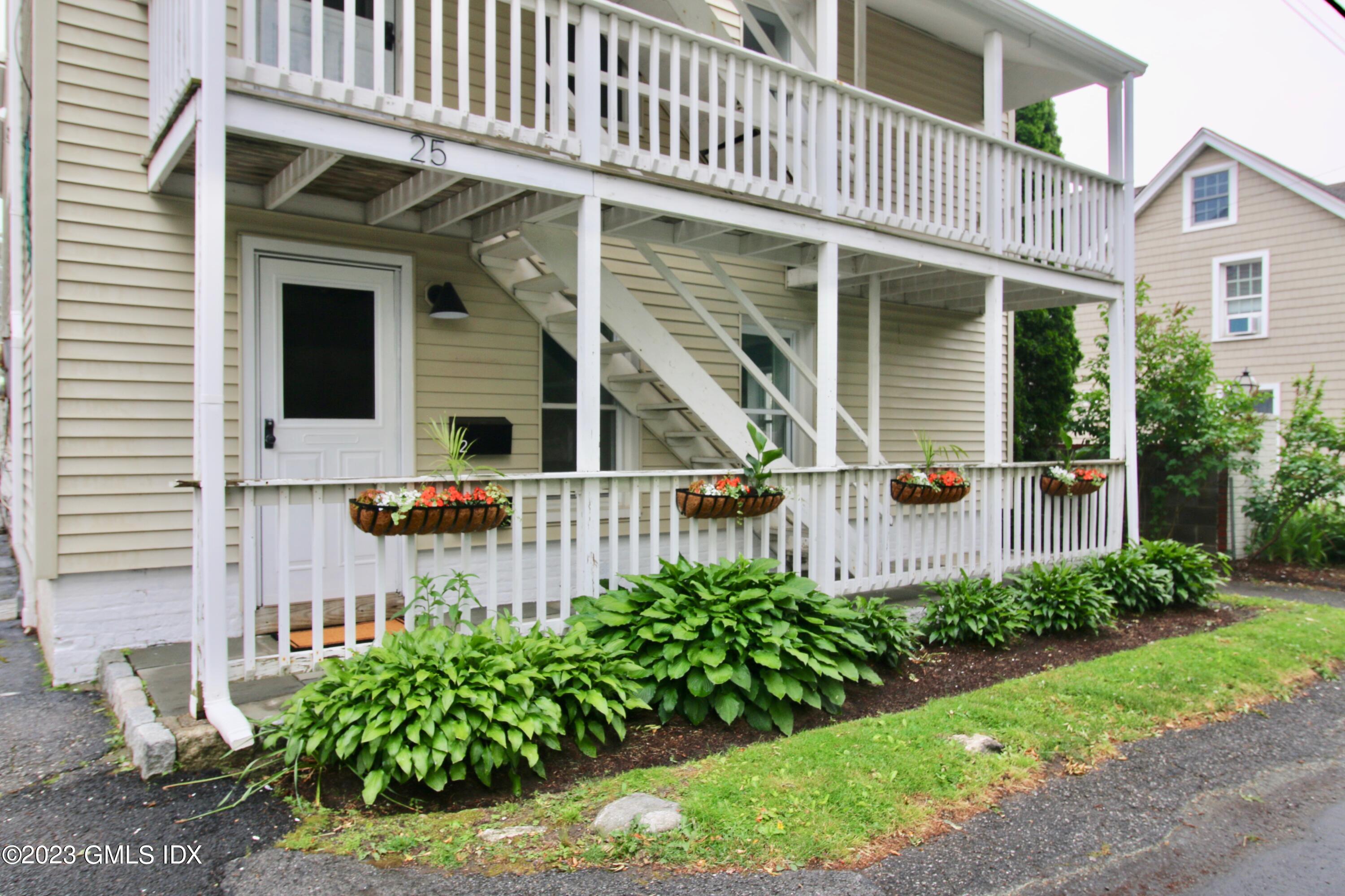 25 Bible Street, Unit 1 Cos Cob, CT 06807 - Photo 2 of 12 a front view of a house with a garden