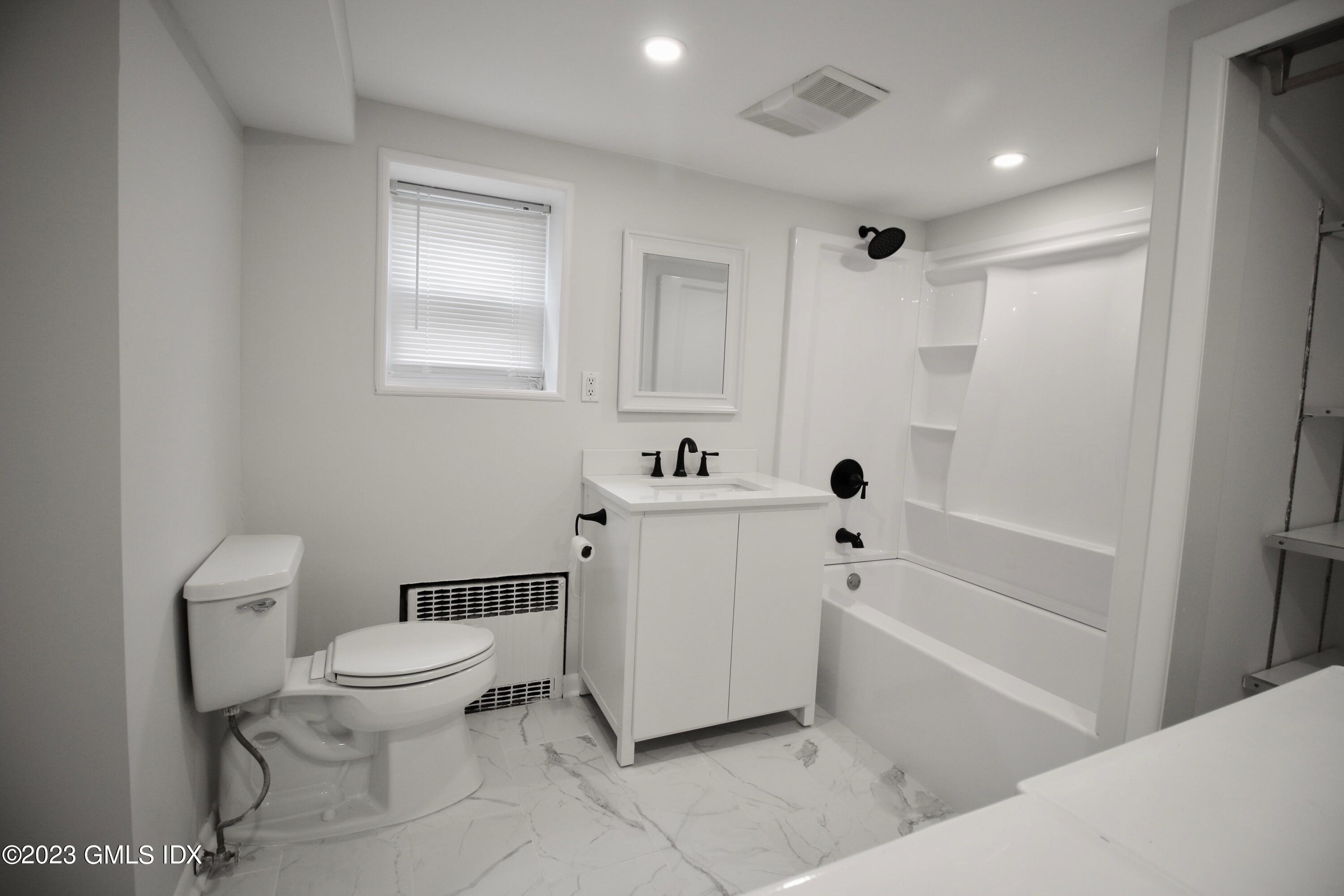 25 Bible Street, Unit 1 Cos Cob, CT 06807 - Photo 10 of 12 a bathroom with a toilet a sink and bathtub