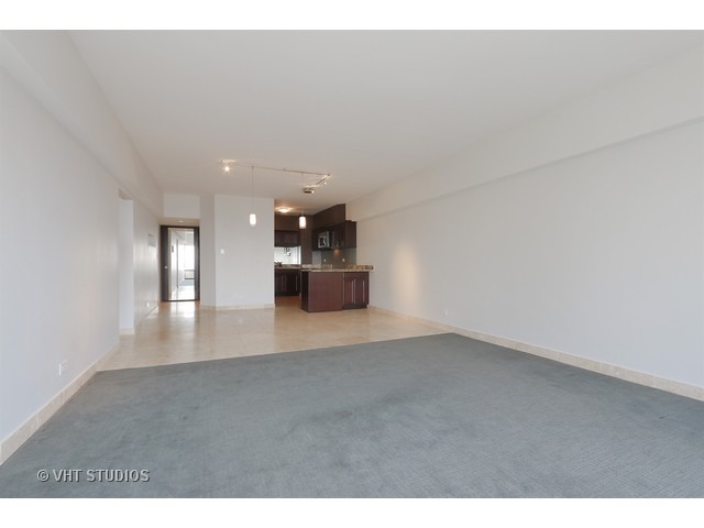 175 East Delaware Place, Unit 6001 Chicago, IL 60611 - Photo 4 of 10 a view of empty room with kitchen