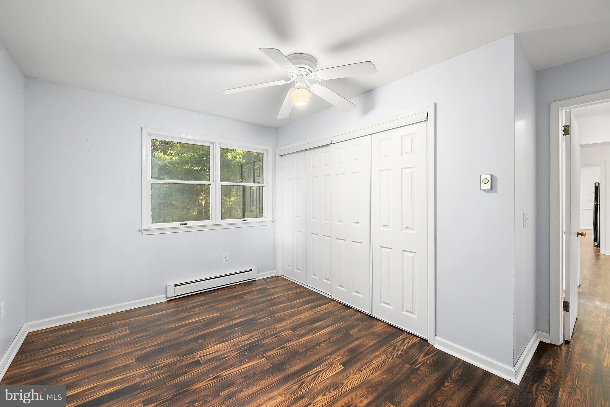 6181 Rockawalkin Road Salisbury, MD 21801 - Photo 26 of 65 an empty room with wooden floor chandelier fan and windows