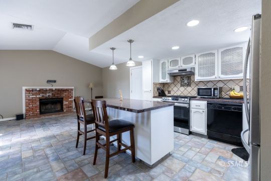 609 South Gemstone Street Ridgecrest, CA 93555 - Photo 10 of 35 a kitchen with kitchen island wooden cabinets and counter space