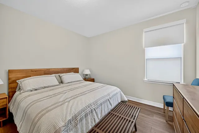 a bedroom with a bed and chair