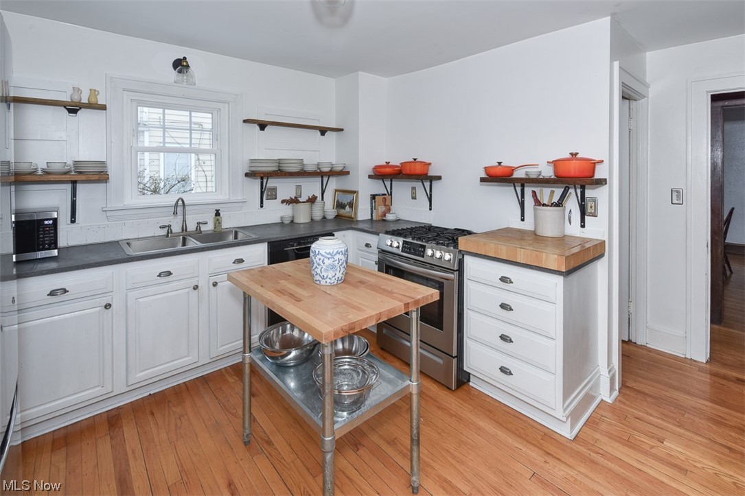 925 Beverly Road Cleveland Heights, OH 44121 - Photo 11 of 25 Kitchen featuring wood counters, appliances with stainless steel finishes, light hardwood / wood-style flooring, white cabinets, and sink