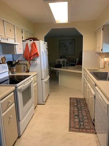 a kitchen with stainless steel appliances and cabinets