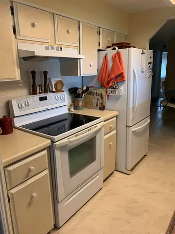 a kitchen with cabinets appliances and a counter top
