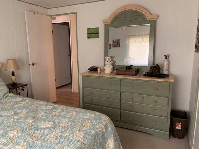 a bed room with a bed and a mirror