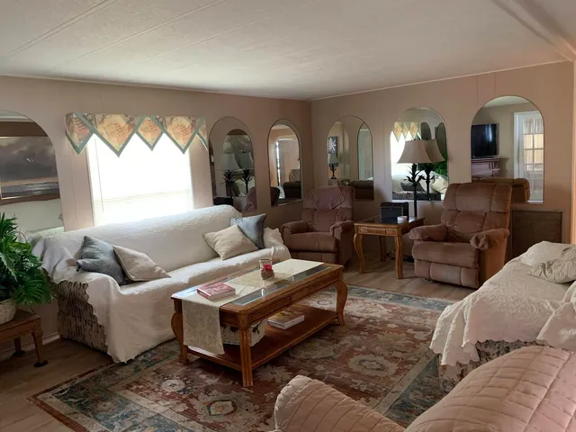 a living room with furniture and a painting on the wall
