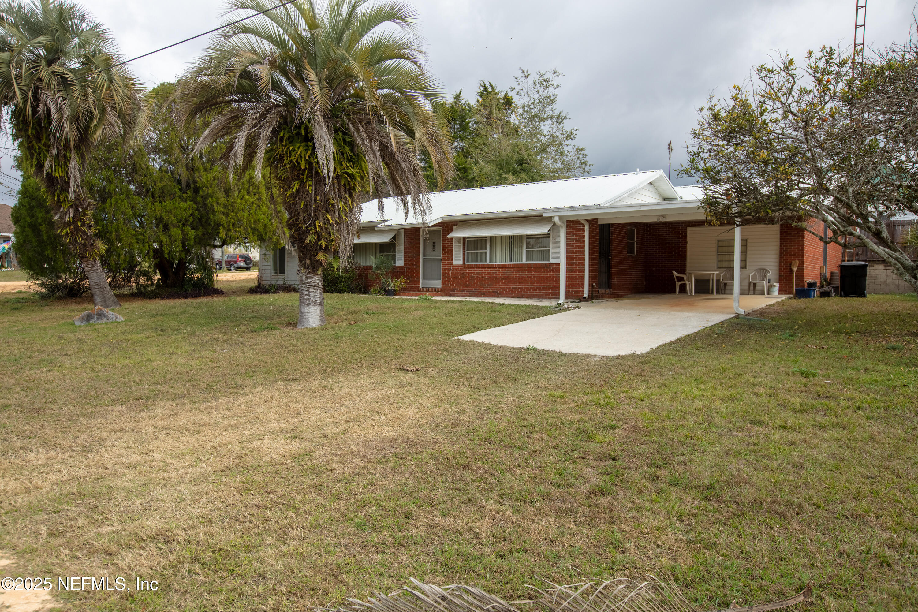 a front view of house with yard and trees