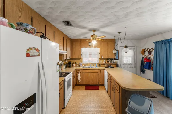 a kitchen with refrigerator and stove