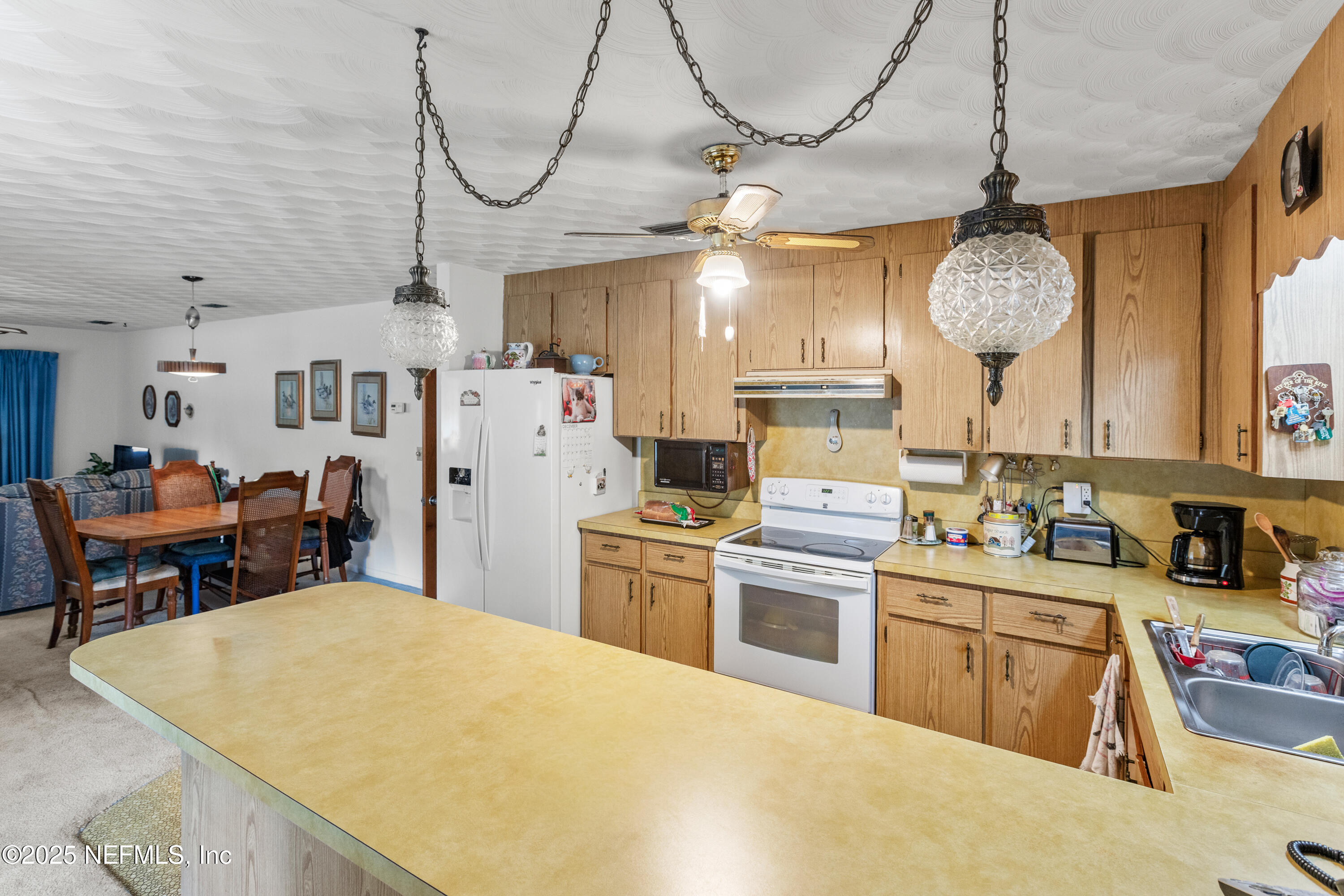 6276 Magnolia Street Keystone Heights, FL 32656 - Photo 12 of 45 a kitchen with sink cabinets and stainless steel appliances