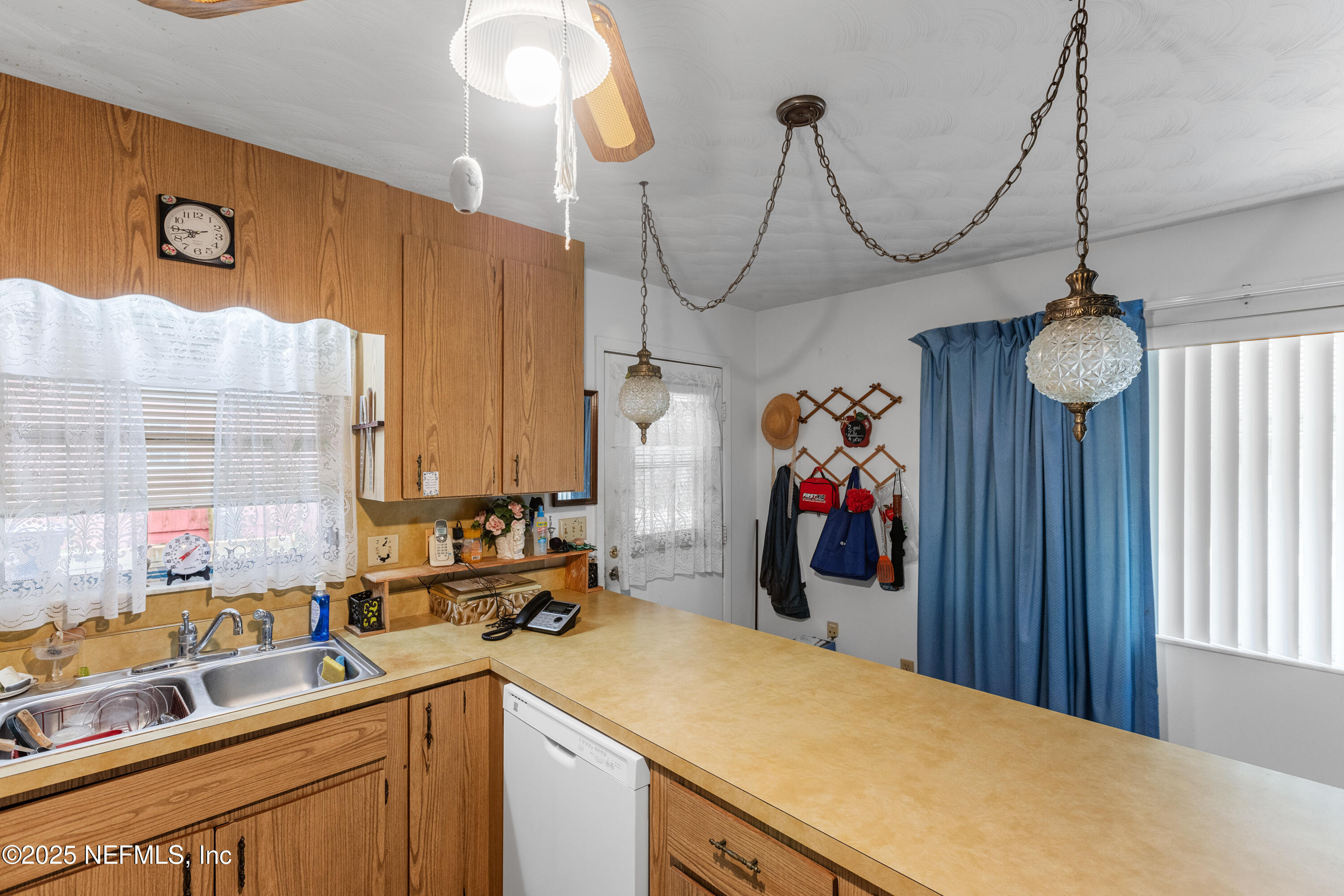 6276 Magnolia Street Keystone Heights, FL 32656 - Photo 13 of 45 a view of a kitchen with a sink and chandelier