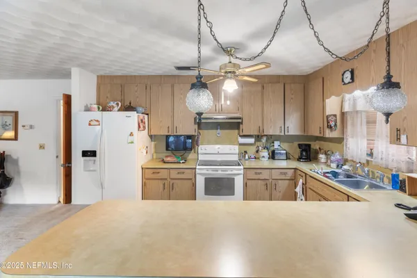a kitchen with refrigerator and cabinets