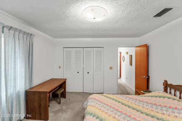 a bedroom with a bed and a table in it