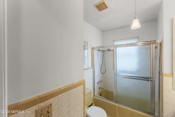 a bathroom with a shower and toilet