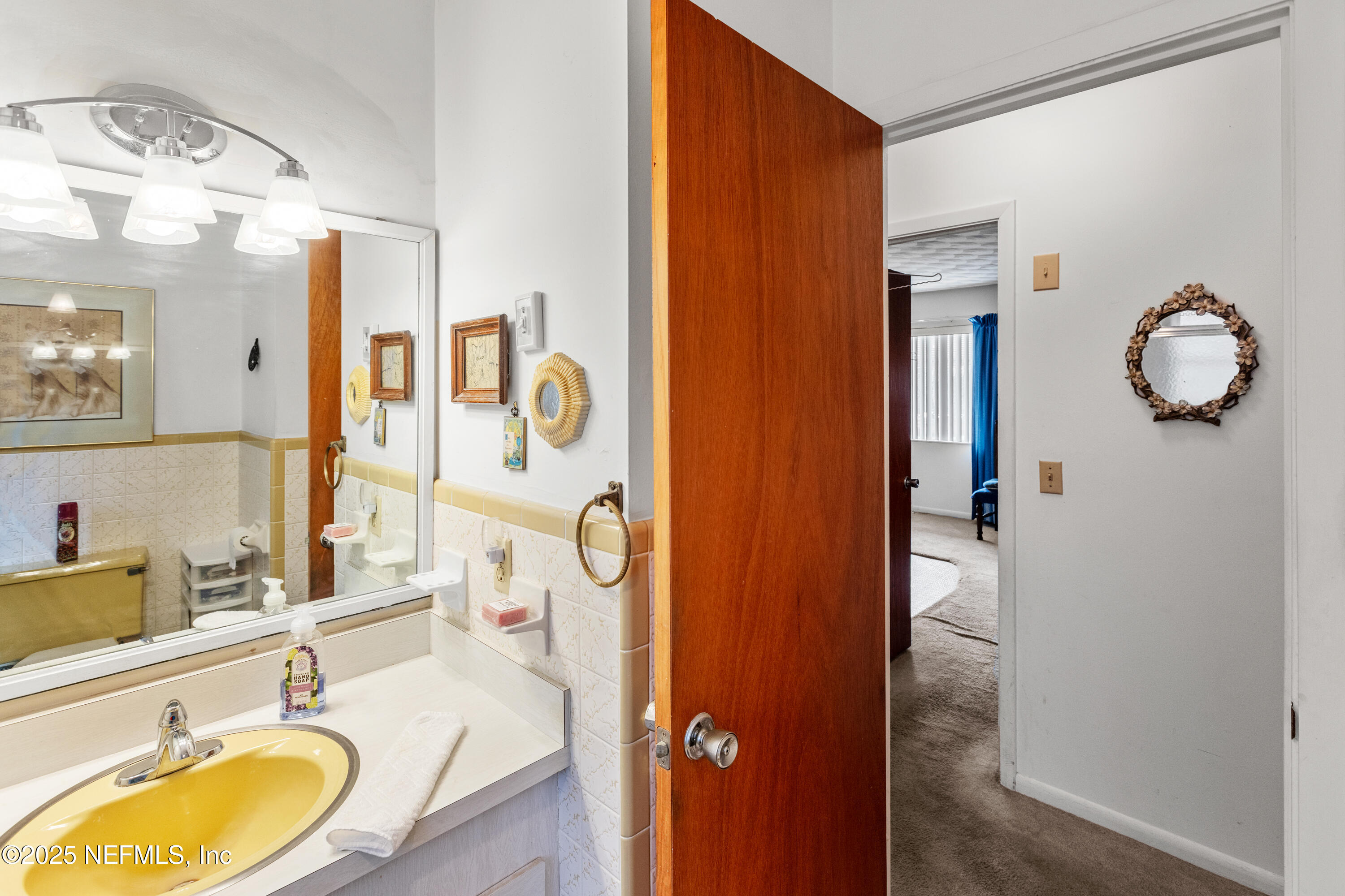 6276 Magnolia Street Keystone Heights, FL 32656 - Photo 23 of 45 a bathroom with a granite countertop sink and a mirror