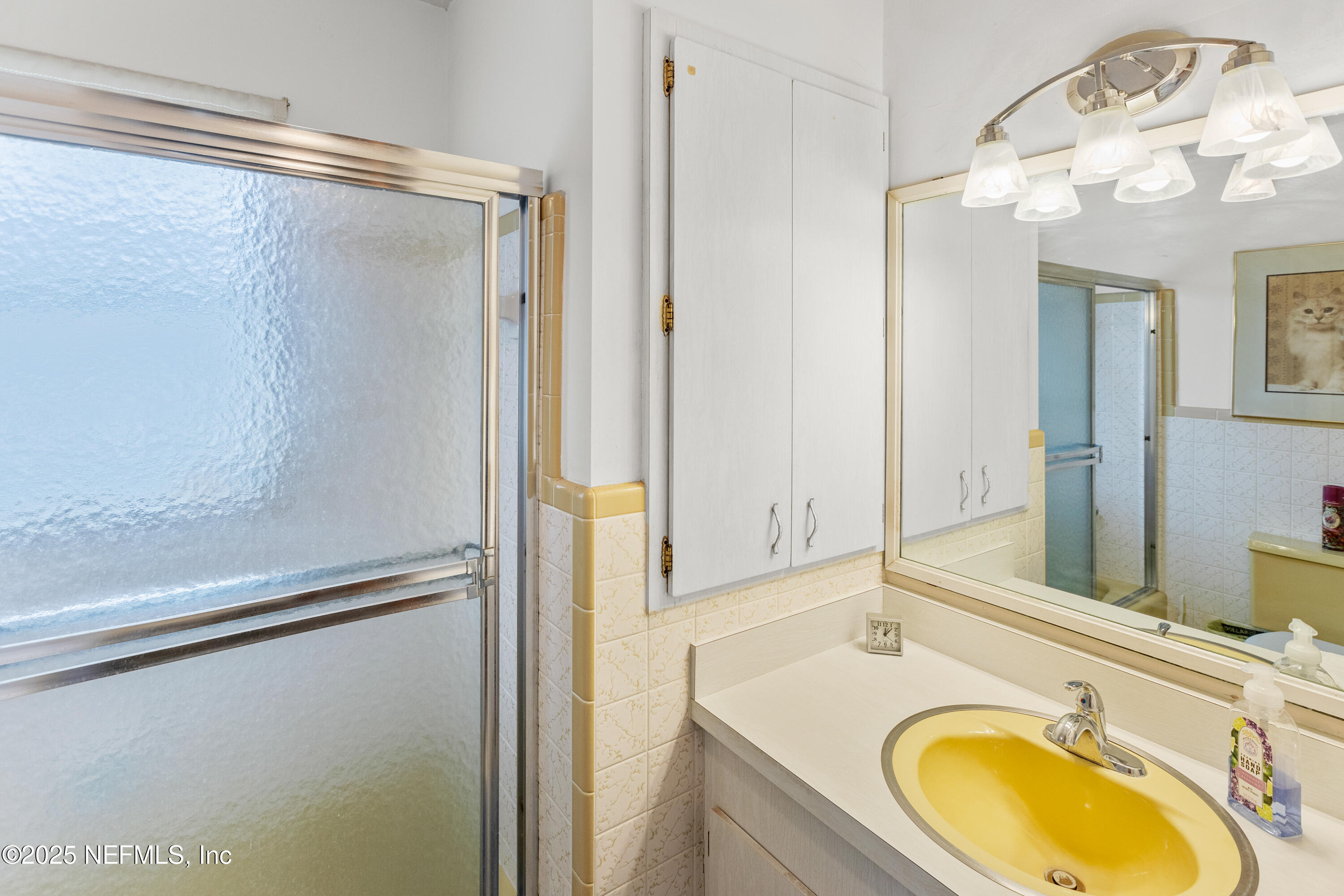 6276 Magnolia Street Keystone Heights, FL 32656 - Photo 24 of 45 a bathroom with a granite countertop sink and a mirror