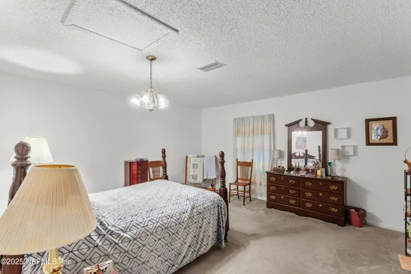 a bedroom with a bed and dresser