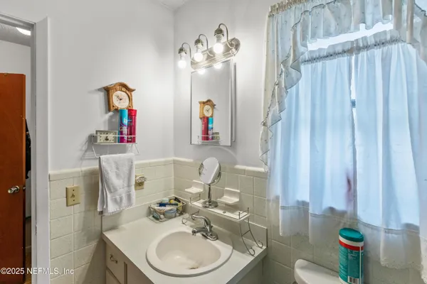 a bathroom with a sink vanity and a mirror