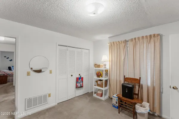 a view of room with workspace and a window