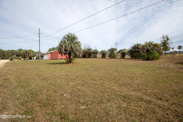 a view of a field with trees