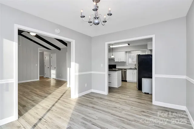 a view of a living room with wooden floor