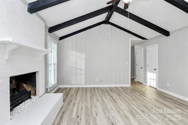 a view of a livingroom with wooden floor and staircase