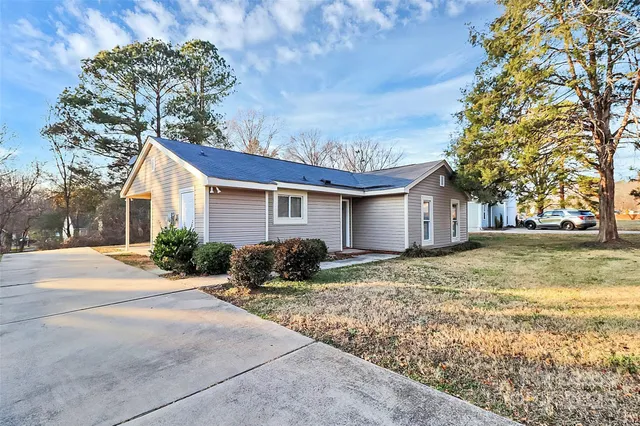 a view of backyard of house and car parked