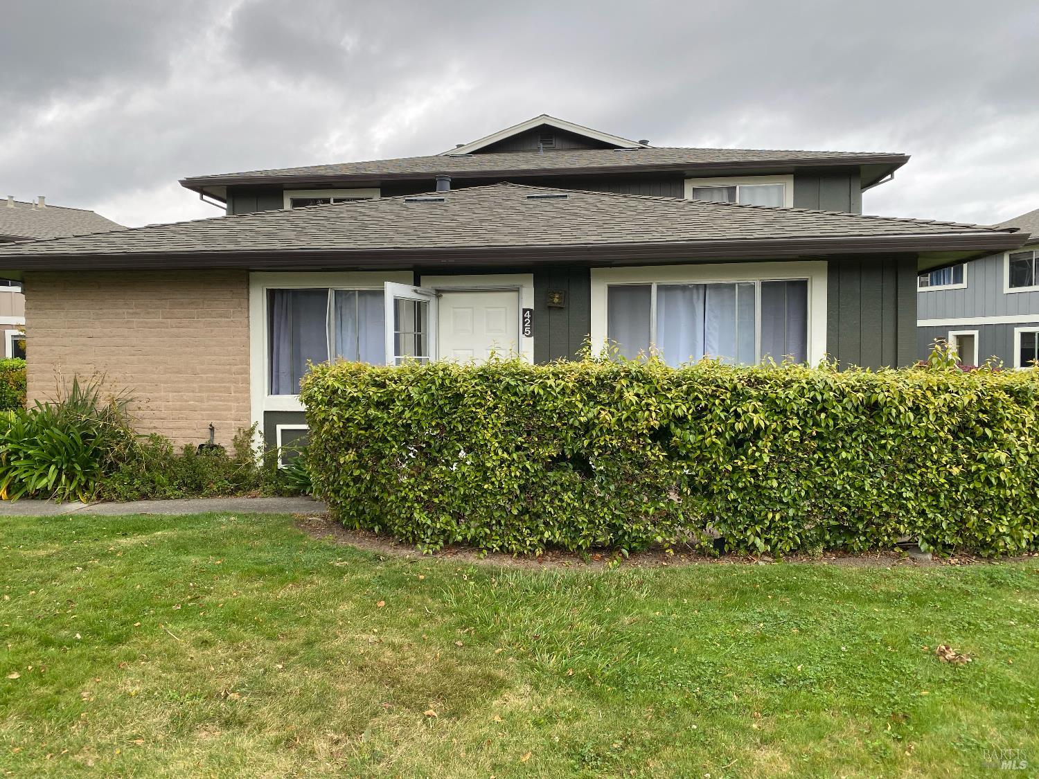 a front view of a house with garden