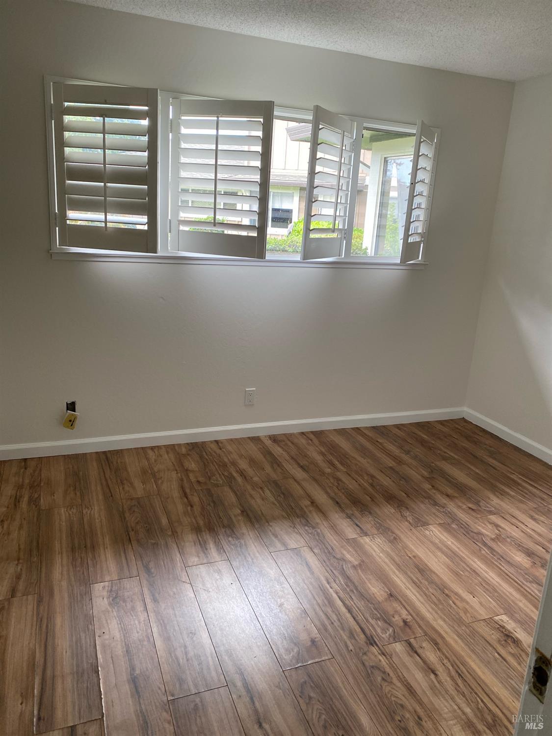 425 Bahia Way San Rafael, CA 94901 - Photo 11 of 18 a view of a room with wooden floor and a window