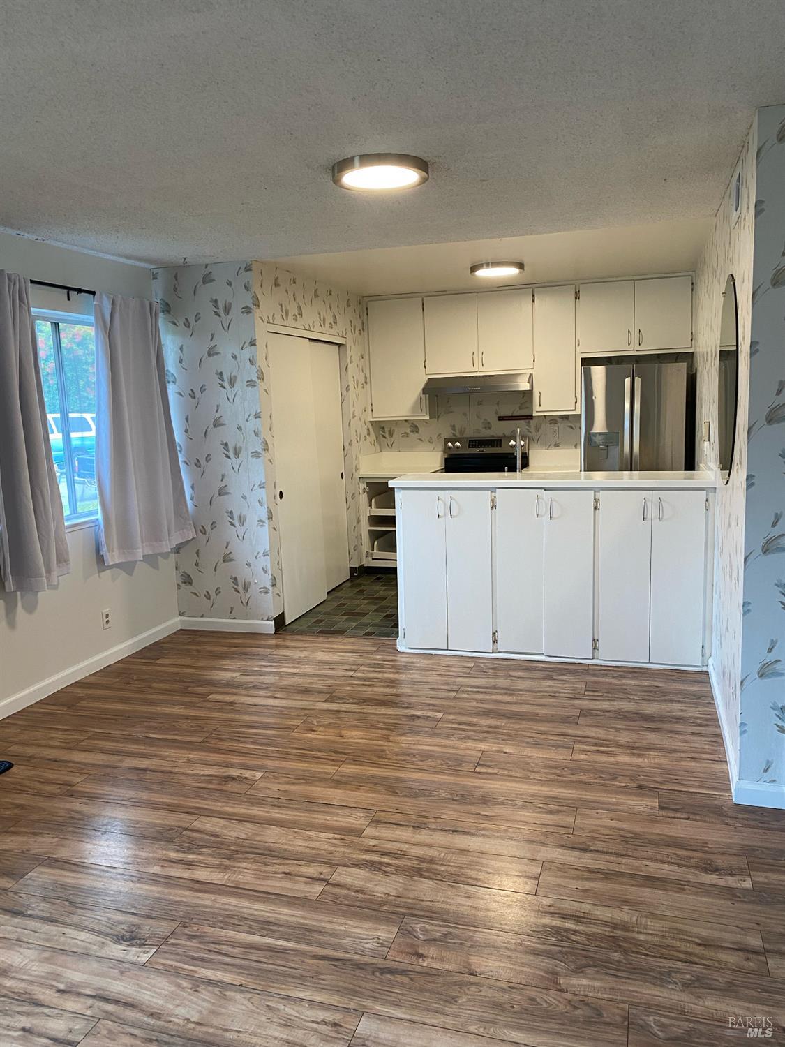 425 Bahia Way San Rafael, CA 94901 - Photo 4 of 18 a kitchen with stainless steel appliances kitchen island granite countertop a refrigerator and a stove top oven
