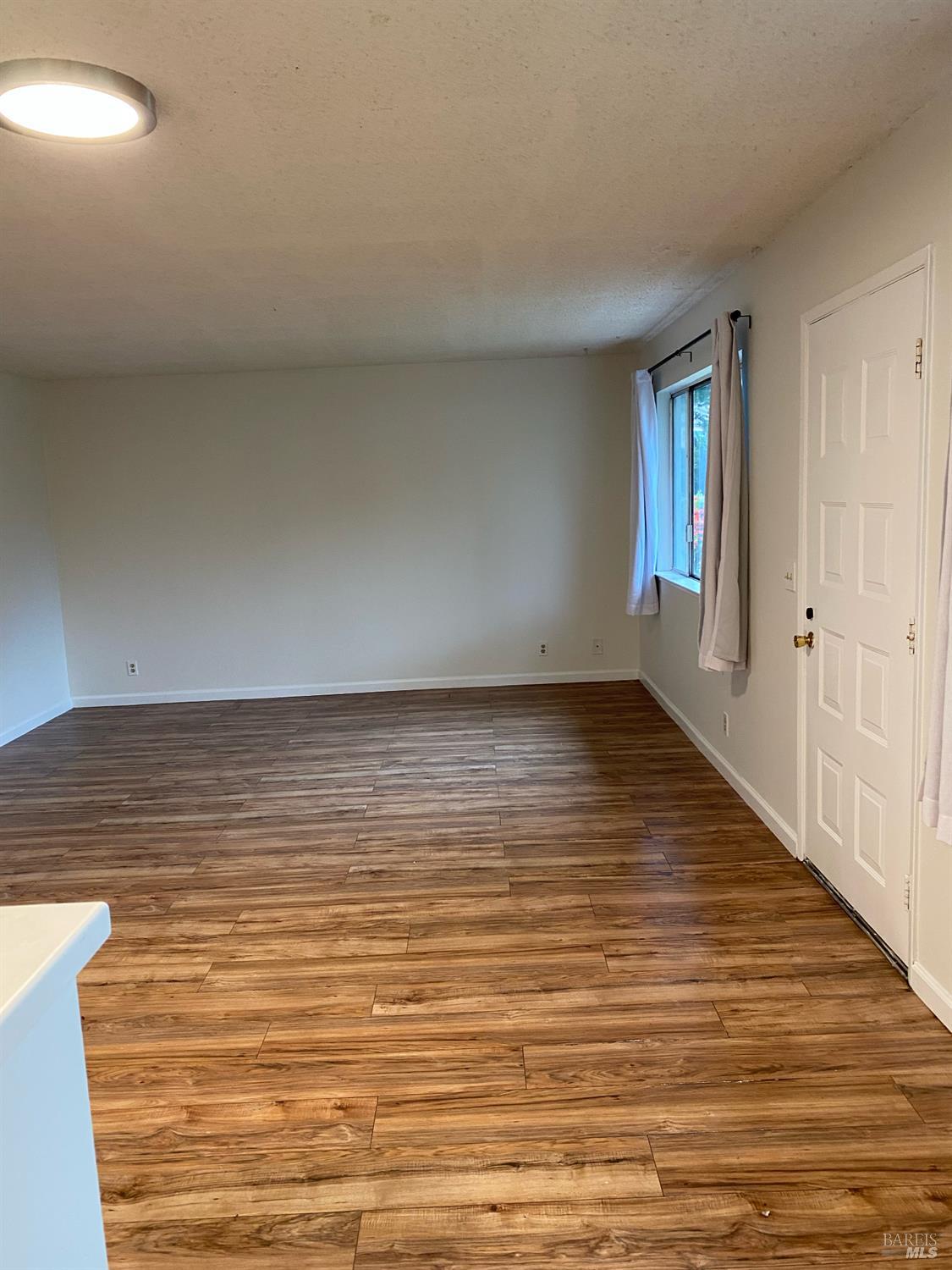 425 Bahia Way San Rafael, CA 94901 - Photo 7 of 18 a view of empty room with wooden floor