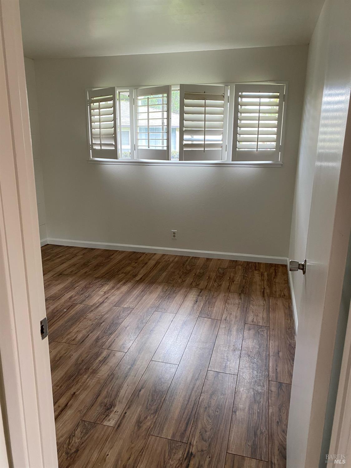425 Bahia Way San Rafael, CA 94901 - Photo 10 of 18 an empty room with wooden floor and windows