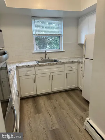 a spacious bathroom with a sink a mirror and a window