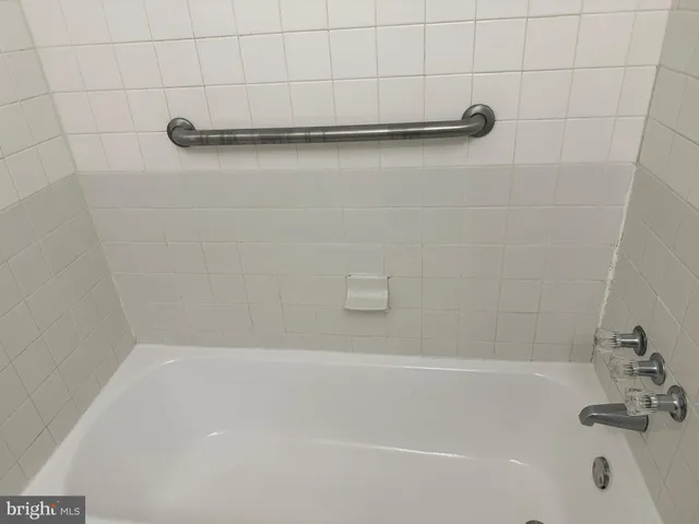 a bathroom with a shower and a bath tub