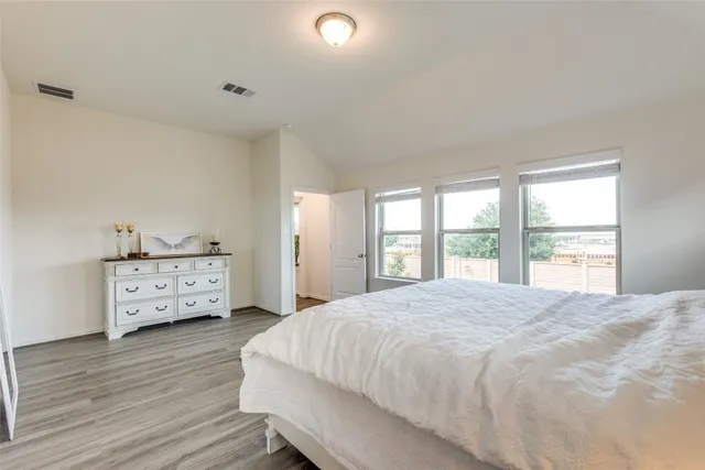 a bedroom with a bed and a large window