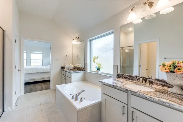 a bathroom with a tub sink and mirror