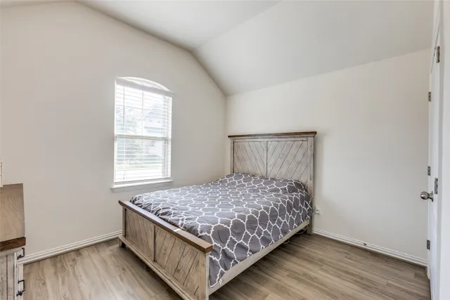 a bed sitting in a bedroom next to a window
